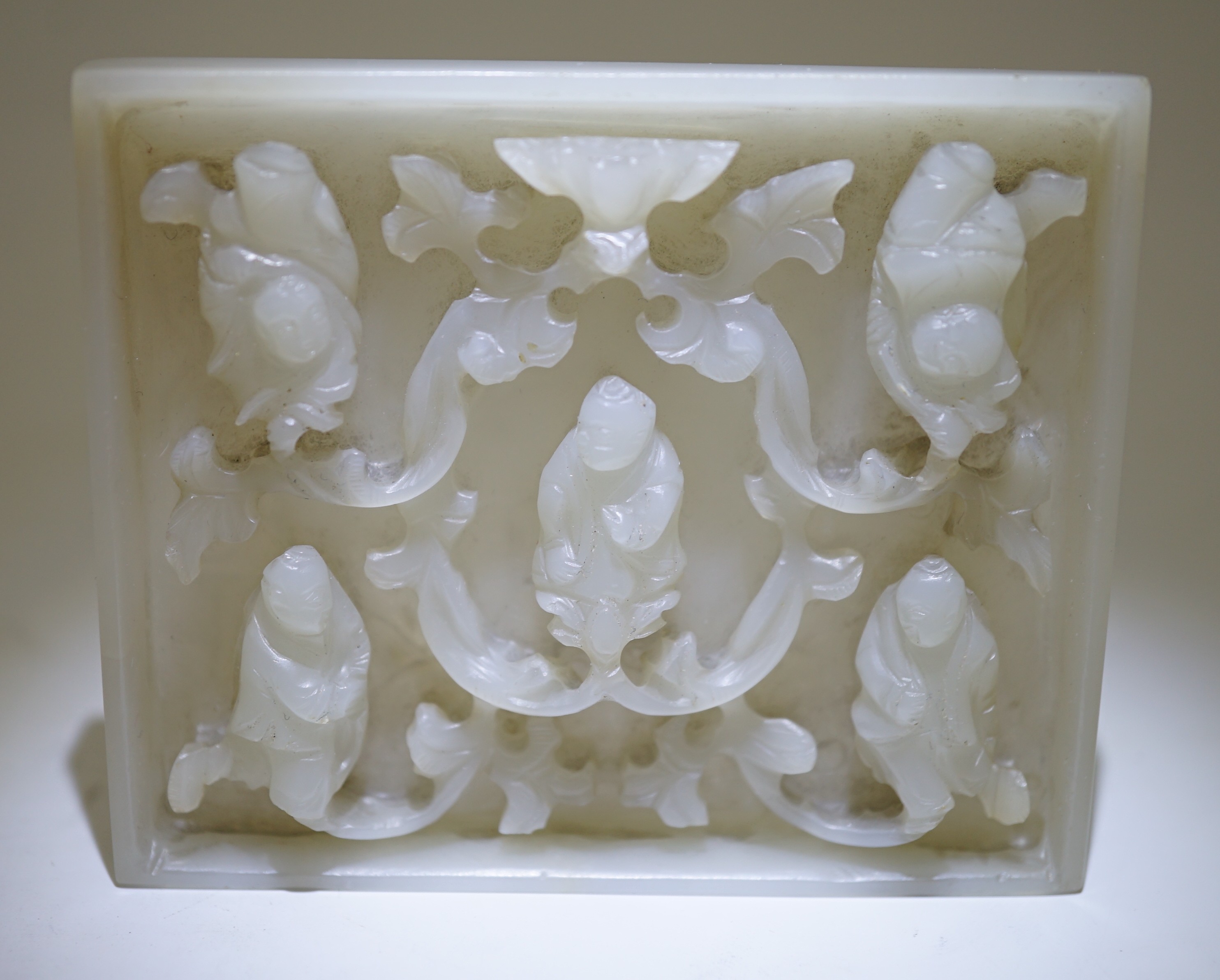 An unusual Chinese white jade plaque, 18th/19th century, 6.7cm x 8.1cm, wood stand
